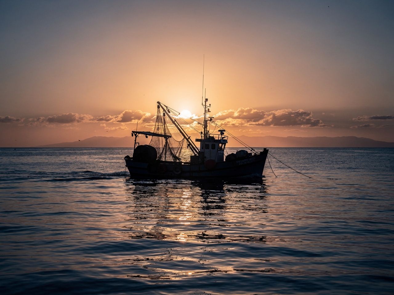 Fishing vessel at sunrise